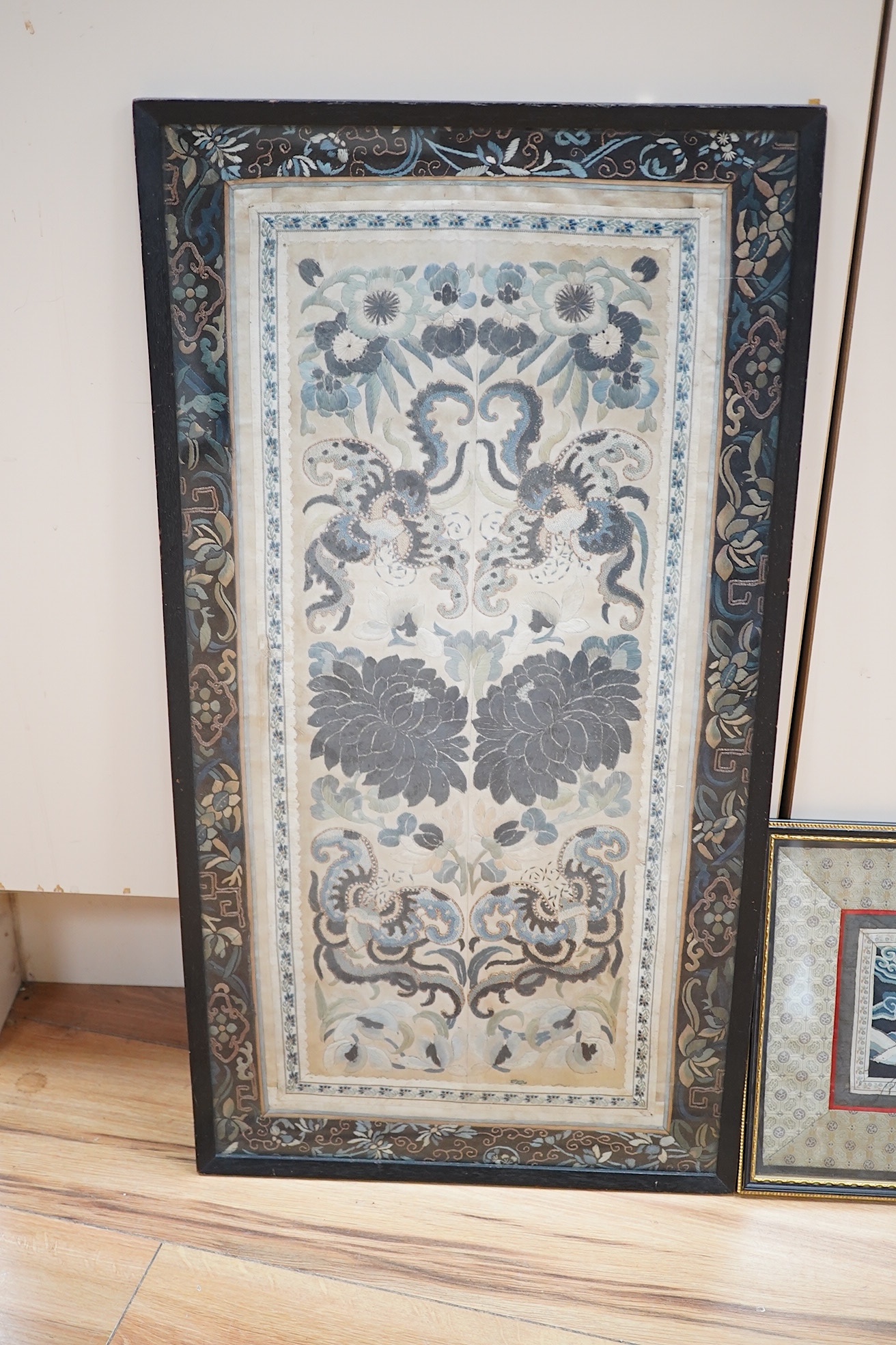 A Chinese framed Kesi gold dragon embroidery, probably originally part of a robe, together with a Chinese framed silk embroidered butterfly sleeve band, both items edged with narrow silk braiding and bordered with silk b